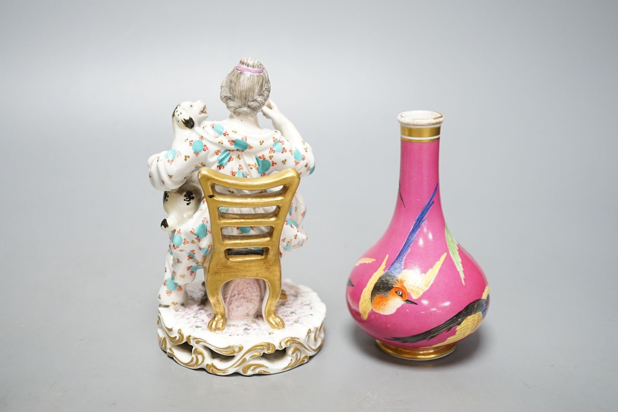 A Minton porcelain figure of a lady seated with a dog c.1830, a pair of Derby figures of a girl and a boy with a dog and a sheep, and a Bloor Derby vase